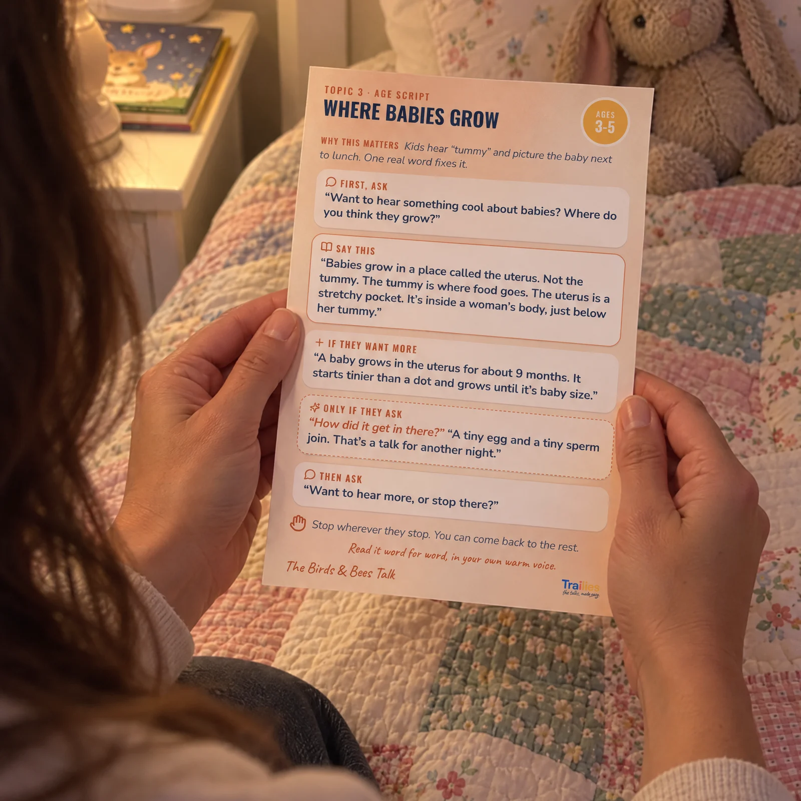 A parent reading the Where Babies Grow card at bedtime