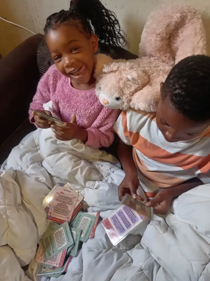 A child at Lolla's Light laughing while going through the Trailies cards