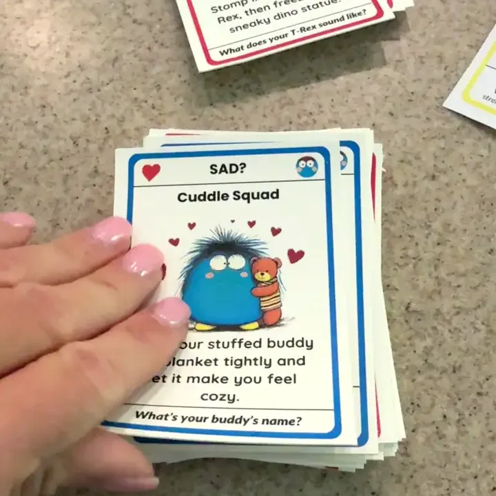 A hand pulling the Cuddle Squad card off the deck mid-moment