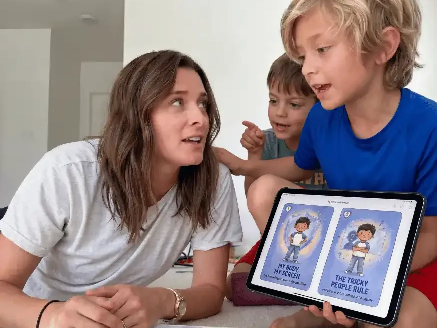 A mom and her two boys going through the Online Safety Talk cards on a tablet