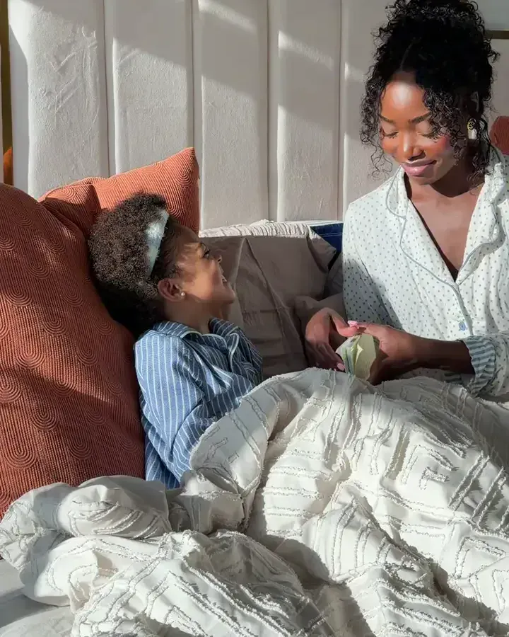 A mom and her child going through a Trailies card together in the morning